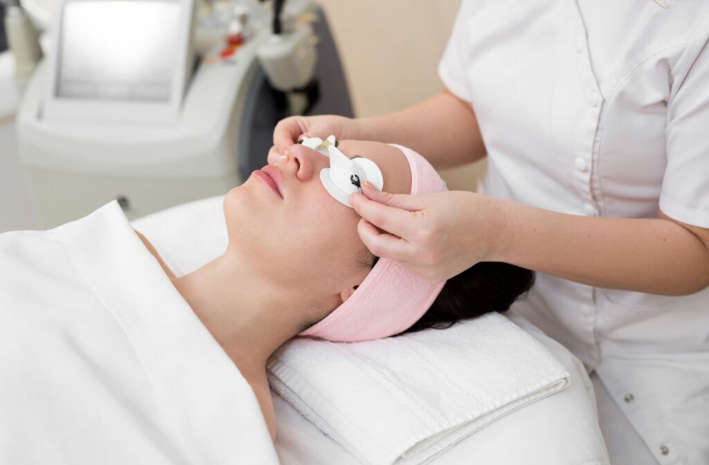 A patient is getting prepped for IPL treatment with a protective eyeshield.